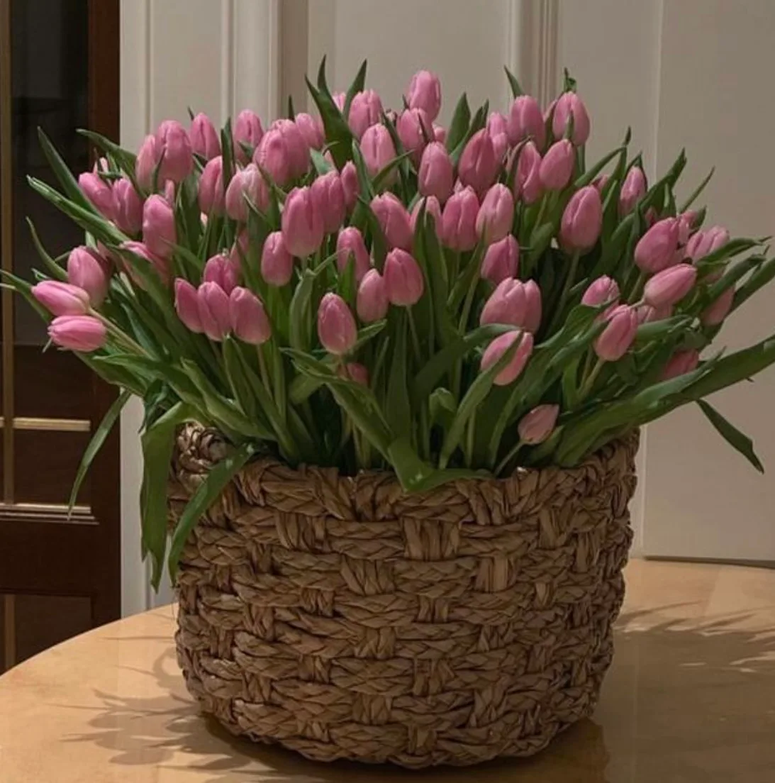 Pink tulips gathered in a woven basket