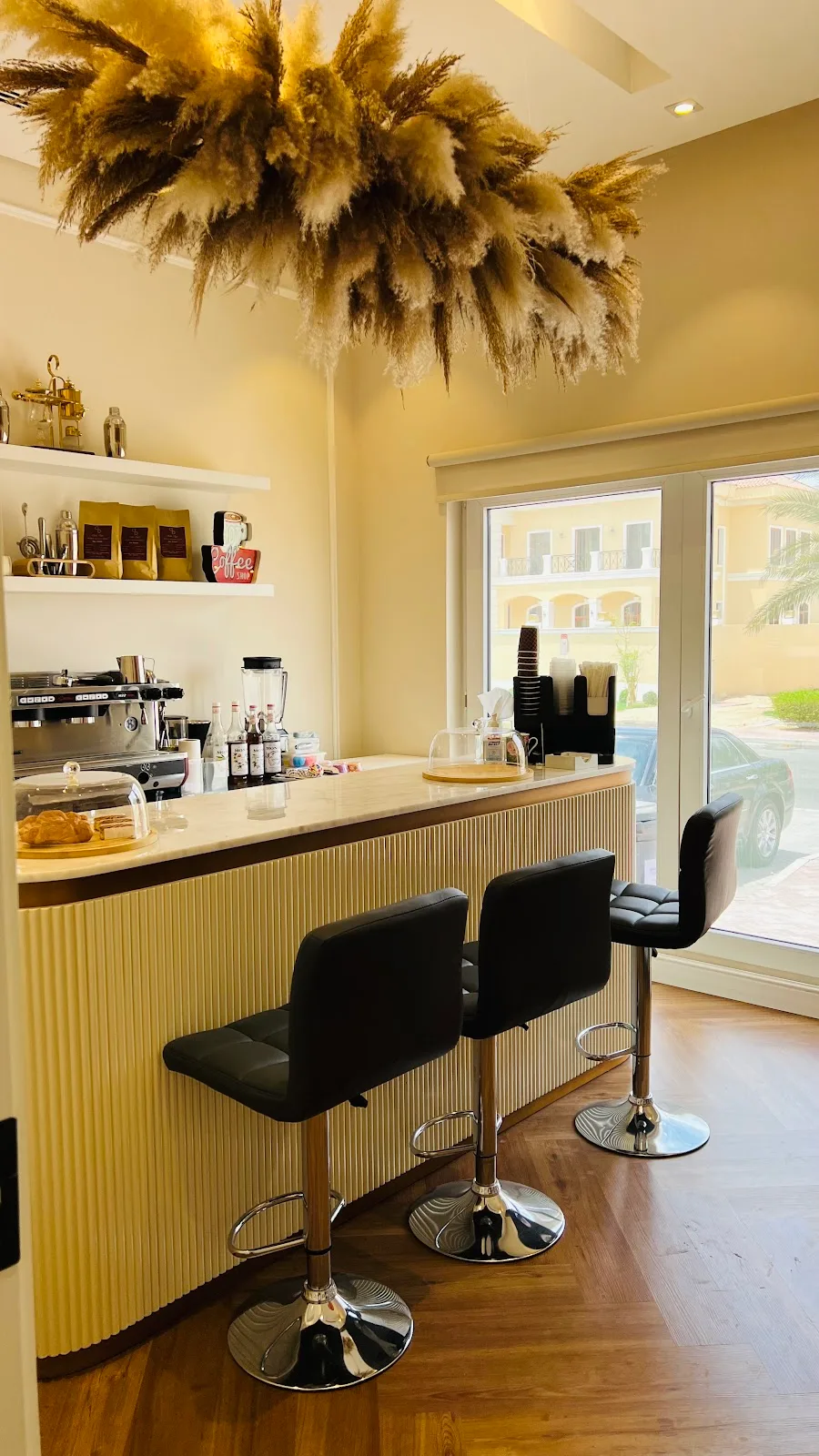 Coffee bar corner with pampas grass and stools