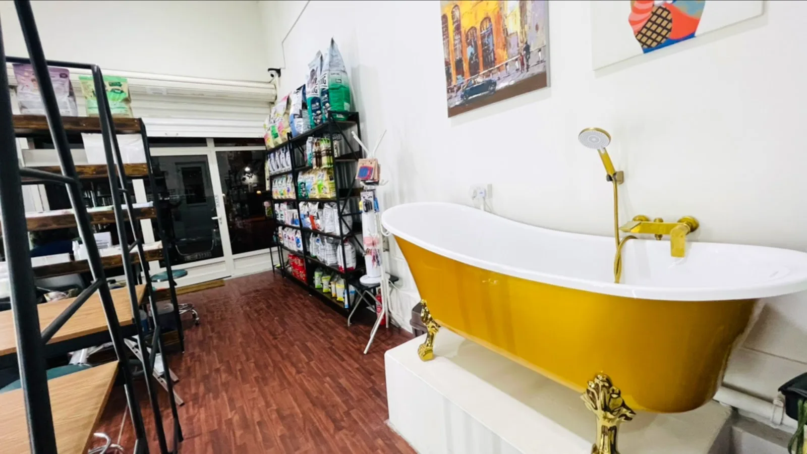 Signature gold clawfoot grooming tub in the Unleash pet spa