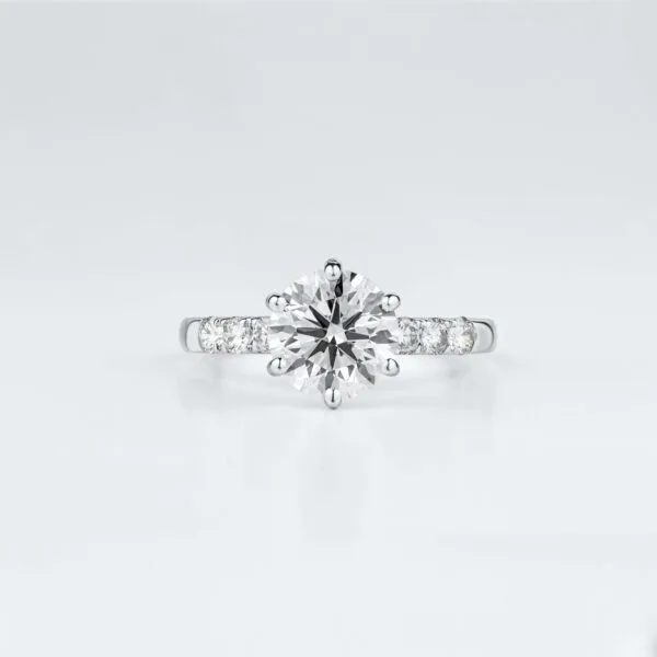 White gold solitaire diamond engagement ring with accent stones