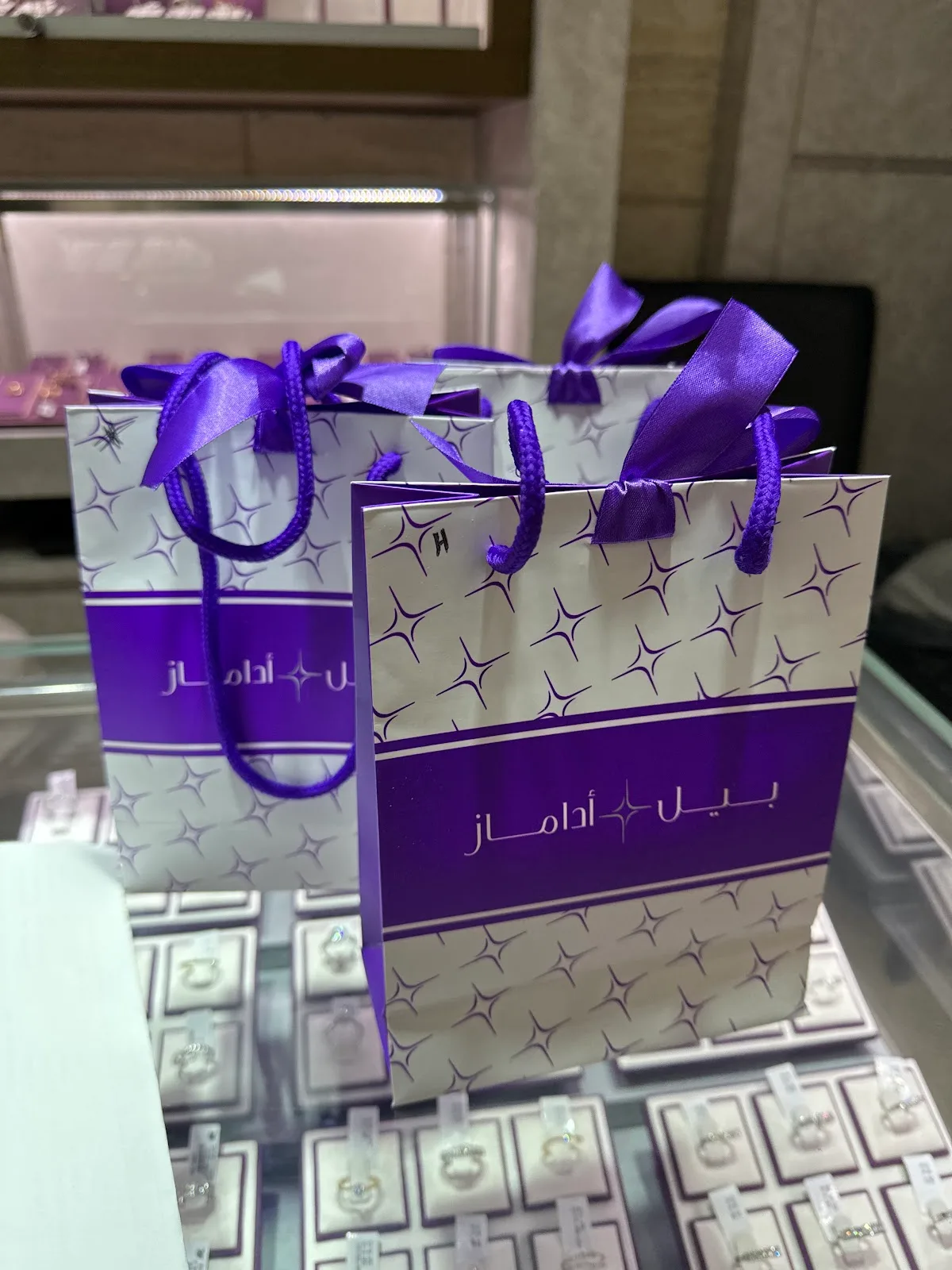 Beladamaz branded shopping bags with purple ribbon