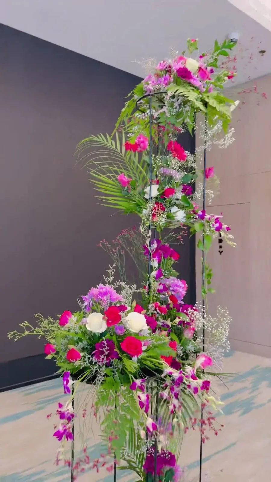Tall floral stand arrangement in pink, magenta and white for an event