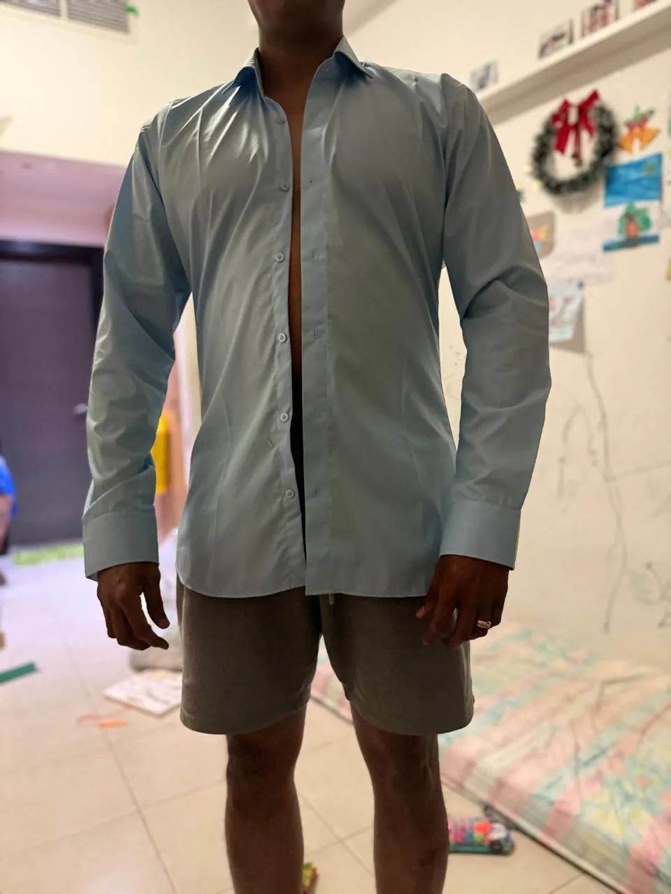 Bespoke light-blue shirt shown front-on to check the fit.