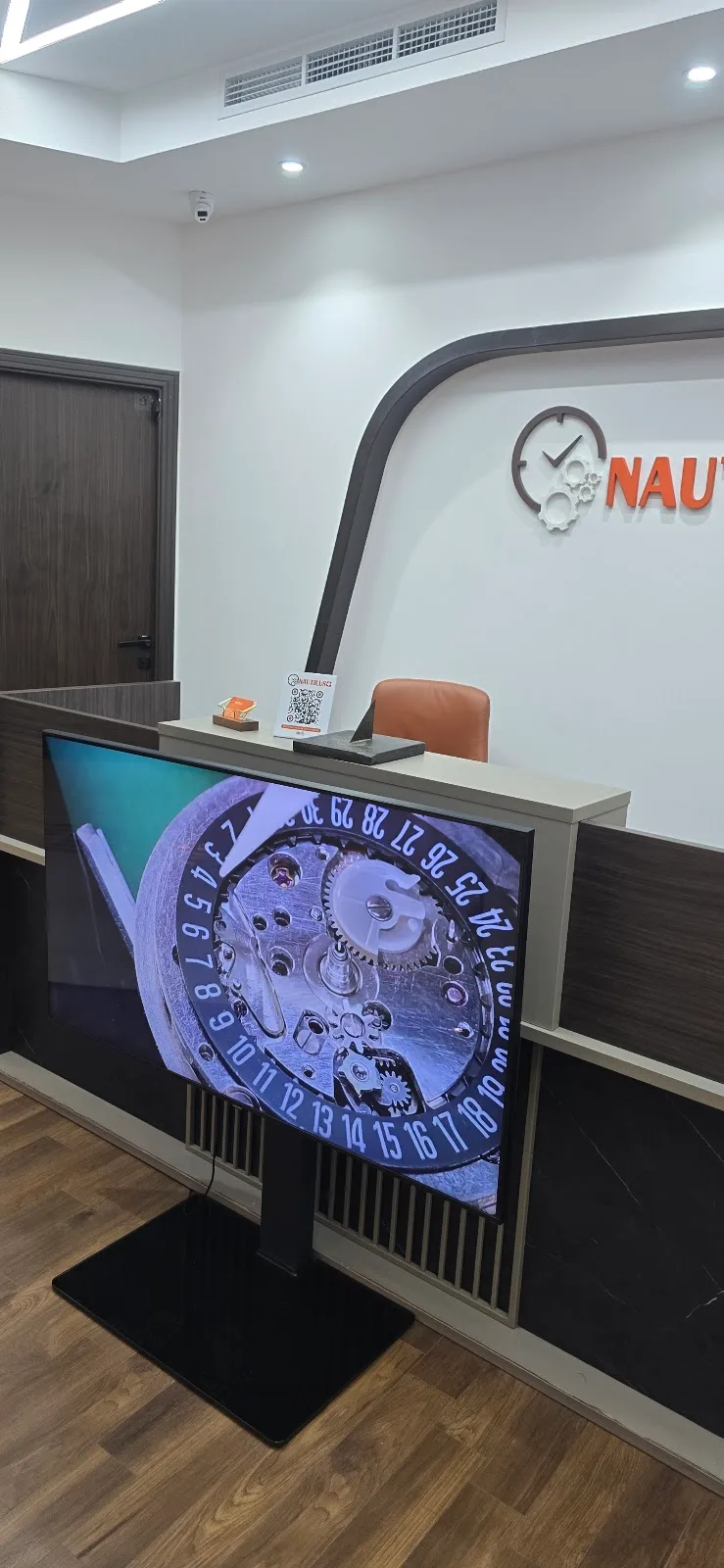 Reception desk with a display screen showing watch movement detail