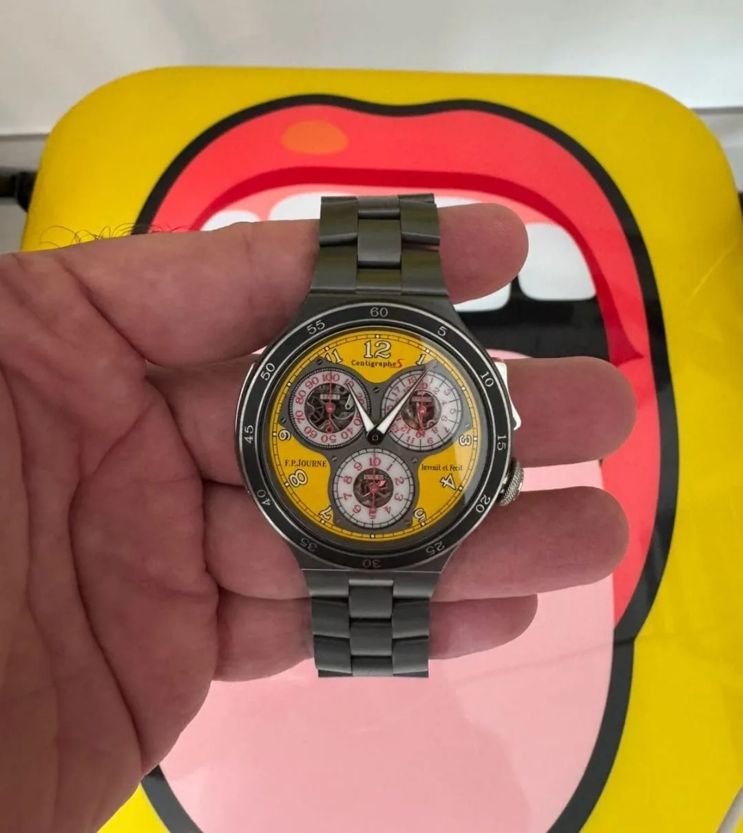 Independent yellow-dial chronograph held in hand
