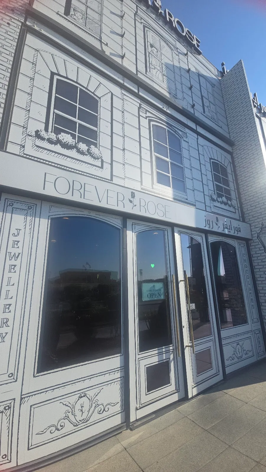 The hand-drawn line-art façade of a Forever Rose boutique