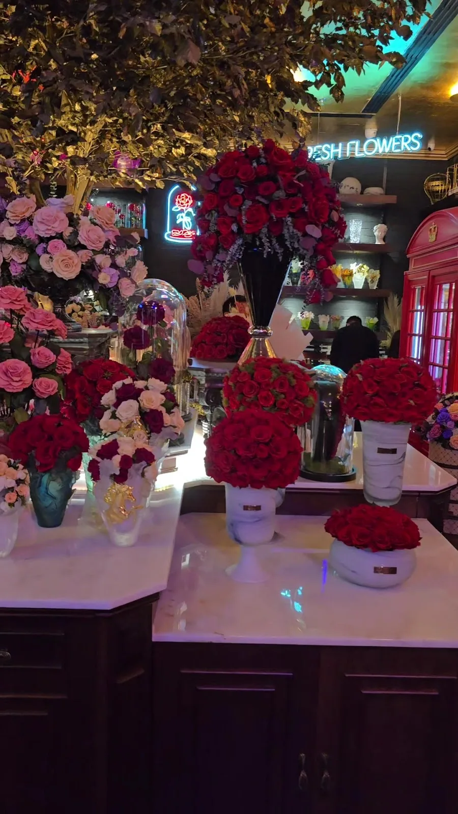 The fresh-flowers room glowing with neon signage and red roses