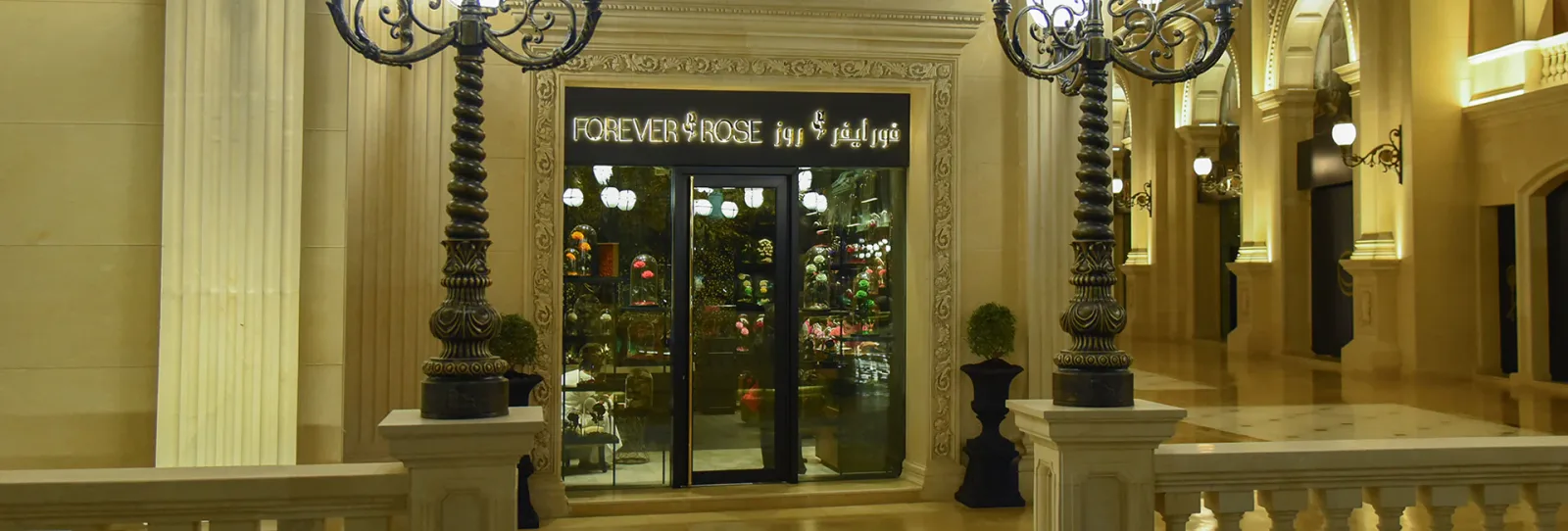 An ornate palatial boutique entrance with carved lamps