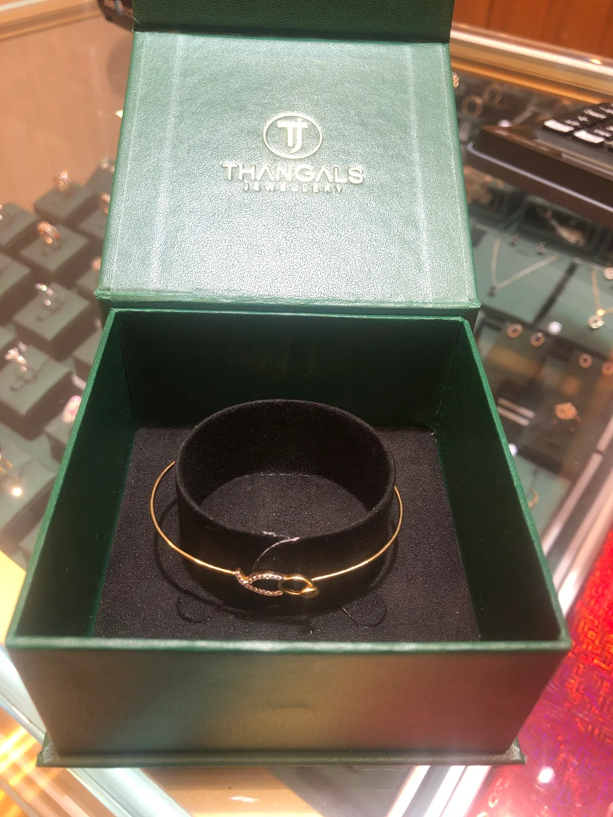 Gold bangle presented in a green Thangals gift box