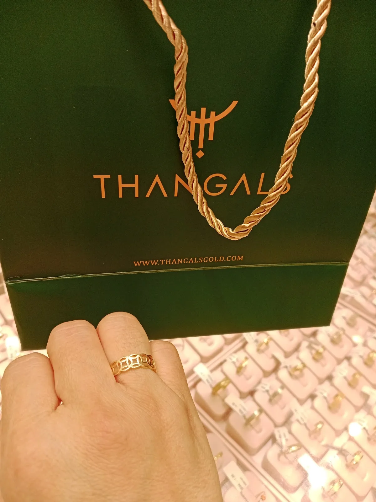 Thangals green gift bag with a gold ring