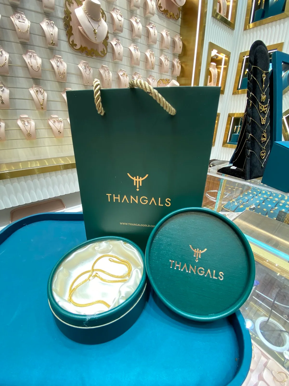 Thangals green gift bag and gift box with a gold chain inside