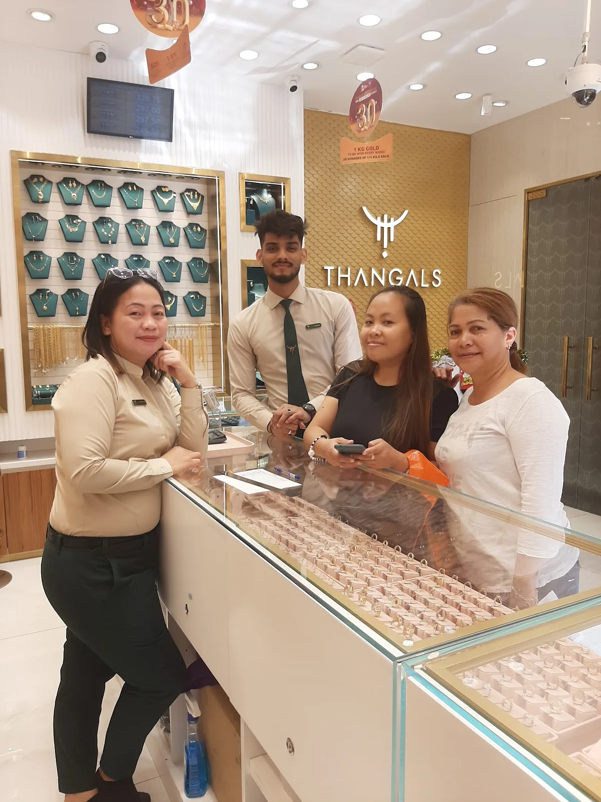 Customers and staff together at the Thangals counter