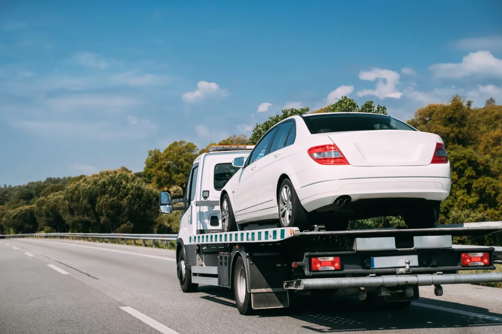 A car secured on a flatbed recovery truck