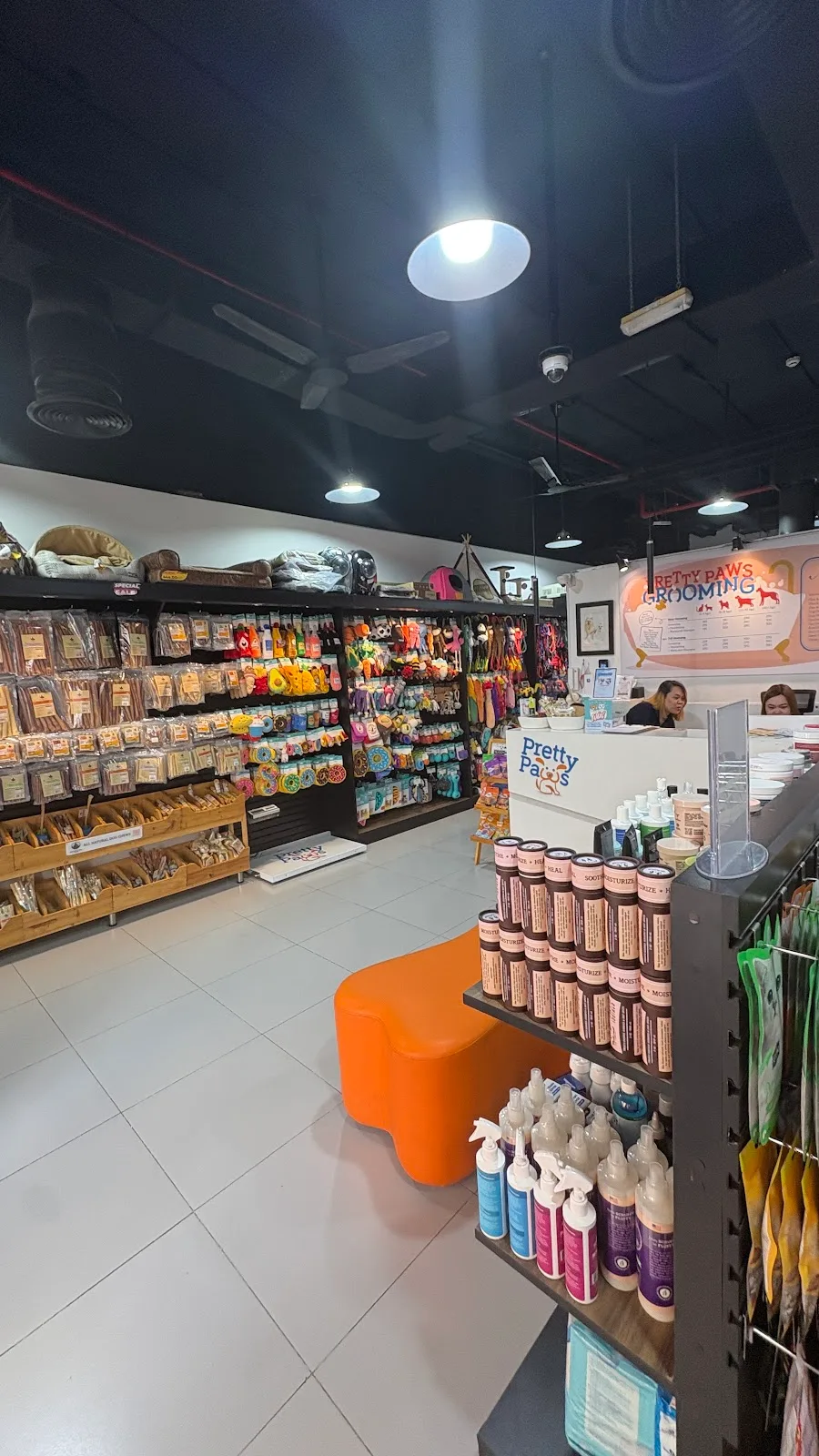 Shelves of treats, food and accessories in the Pretty Paws pet store