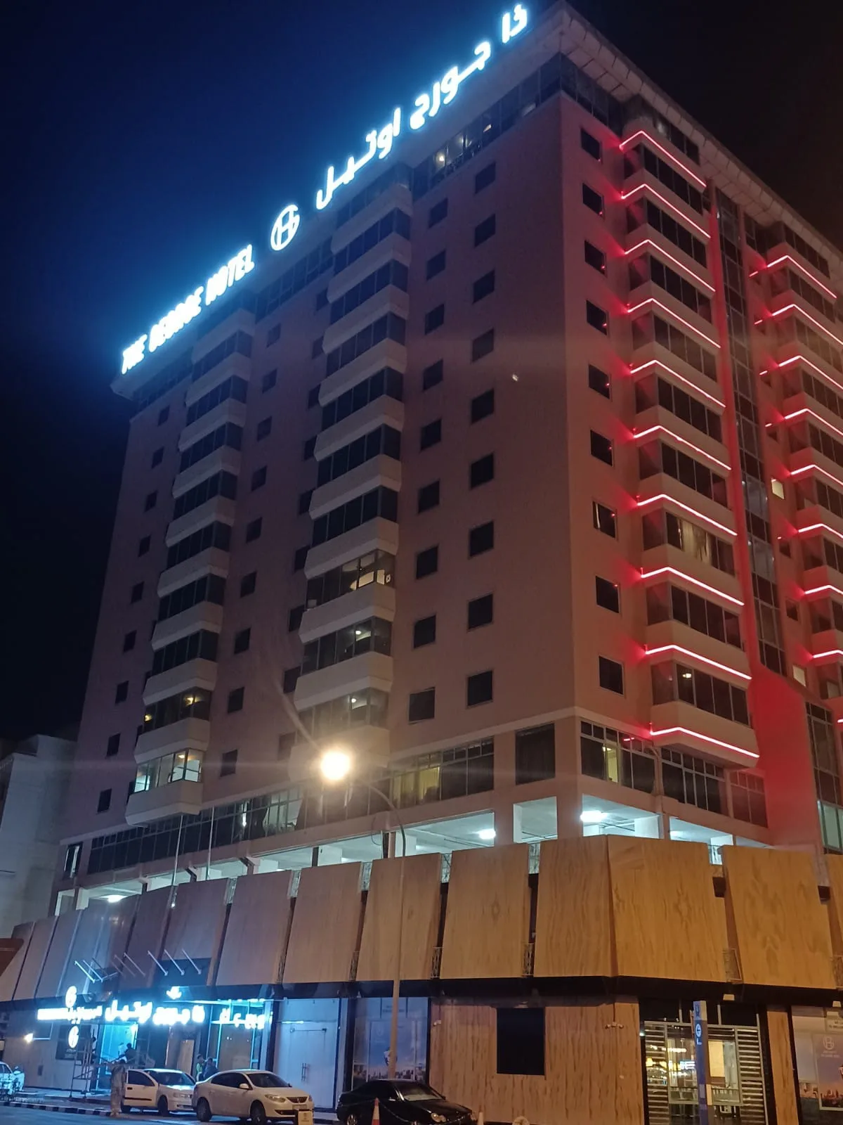 Rooftop illuminated lettering on a hotel at night
