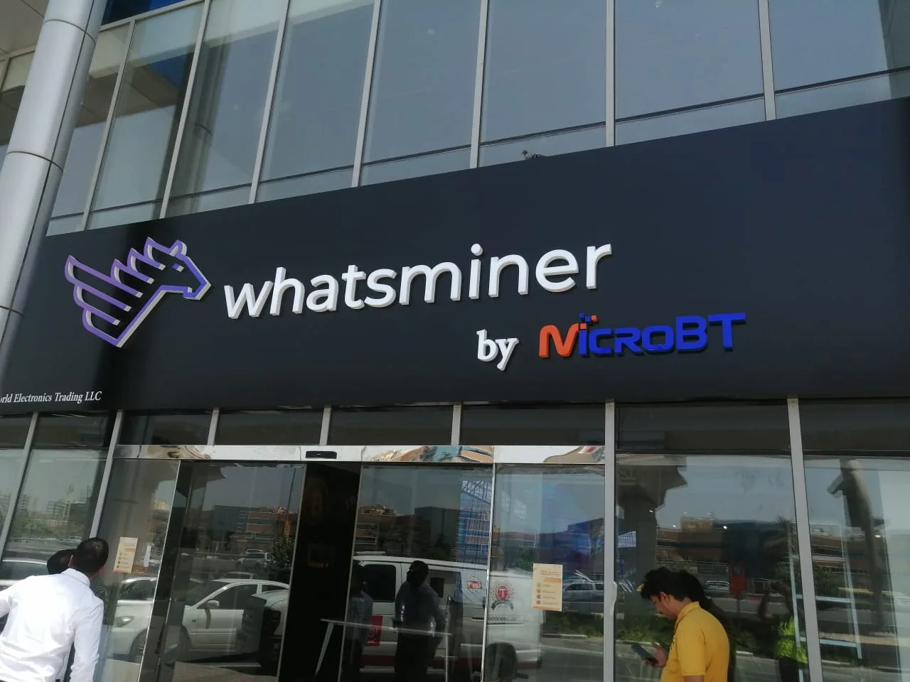 Building façade brand signage above a glass entrance