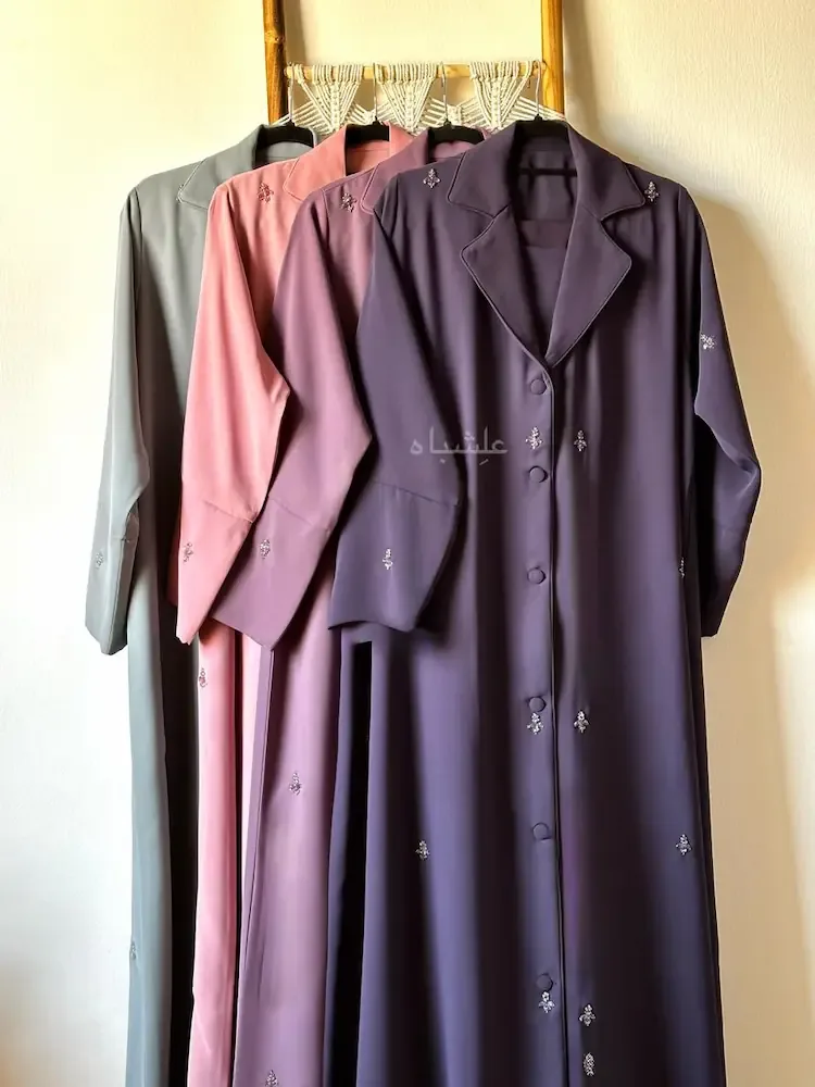 Black abaya with scattered lavender and green floral embroidery down the sleeve