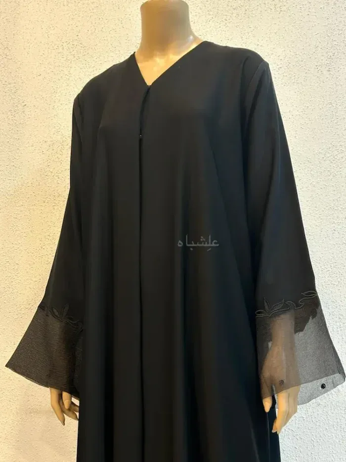 Black abaya with sheer mesh cuffs and subtle embroidered trim