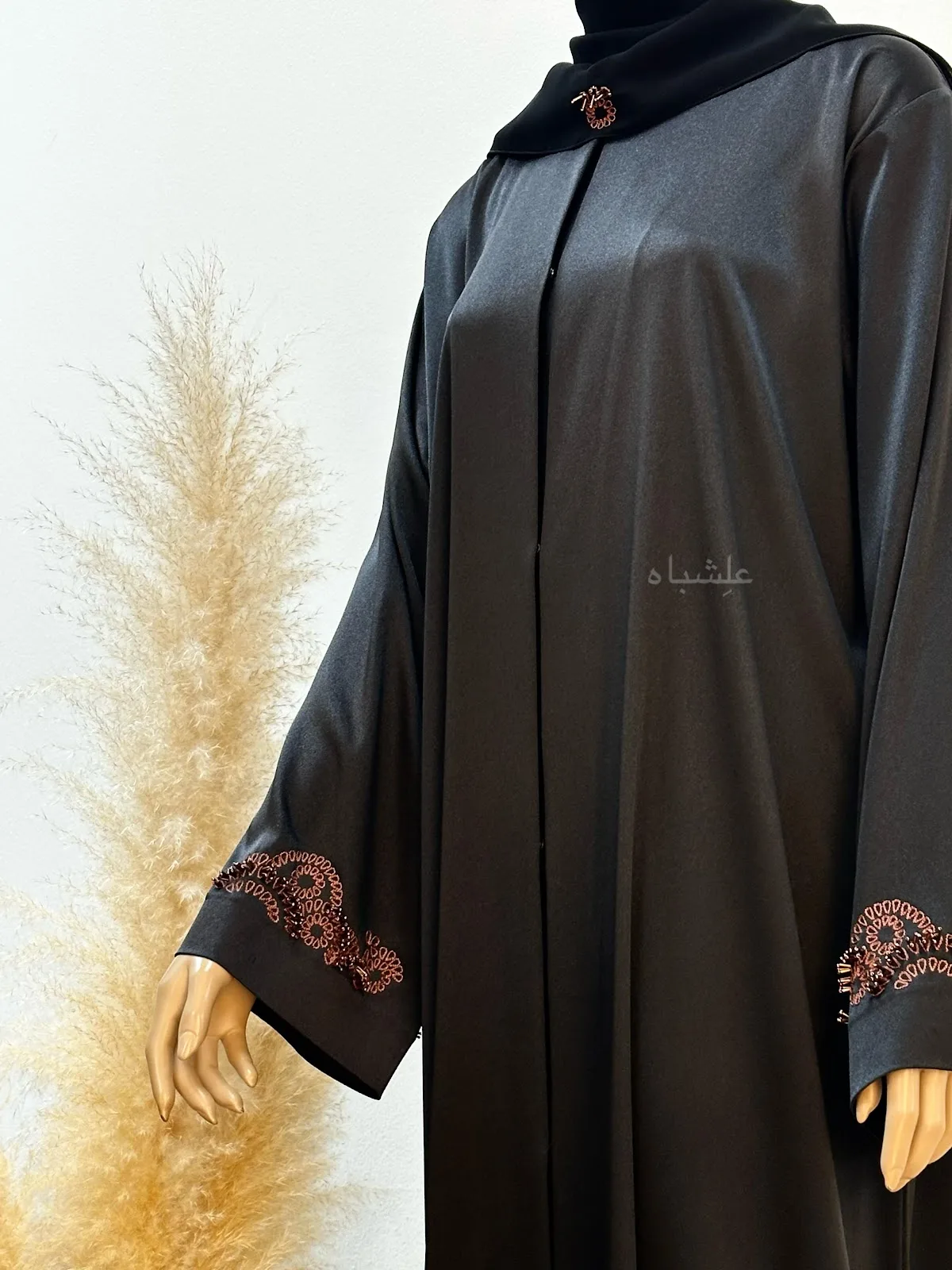 Three abayas in blush and lilac tones with beaded sleeve detailing held side by side