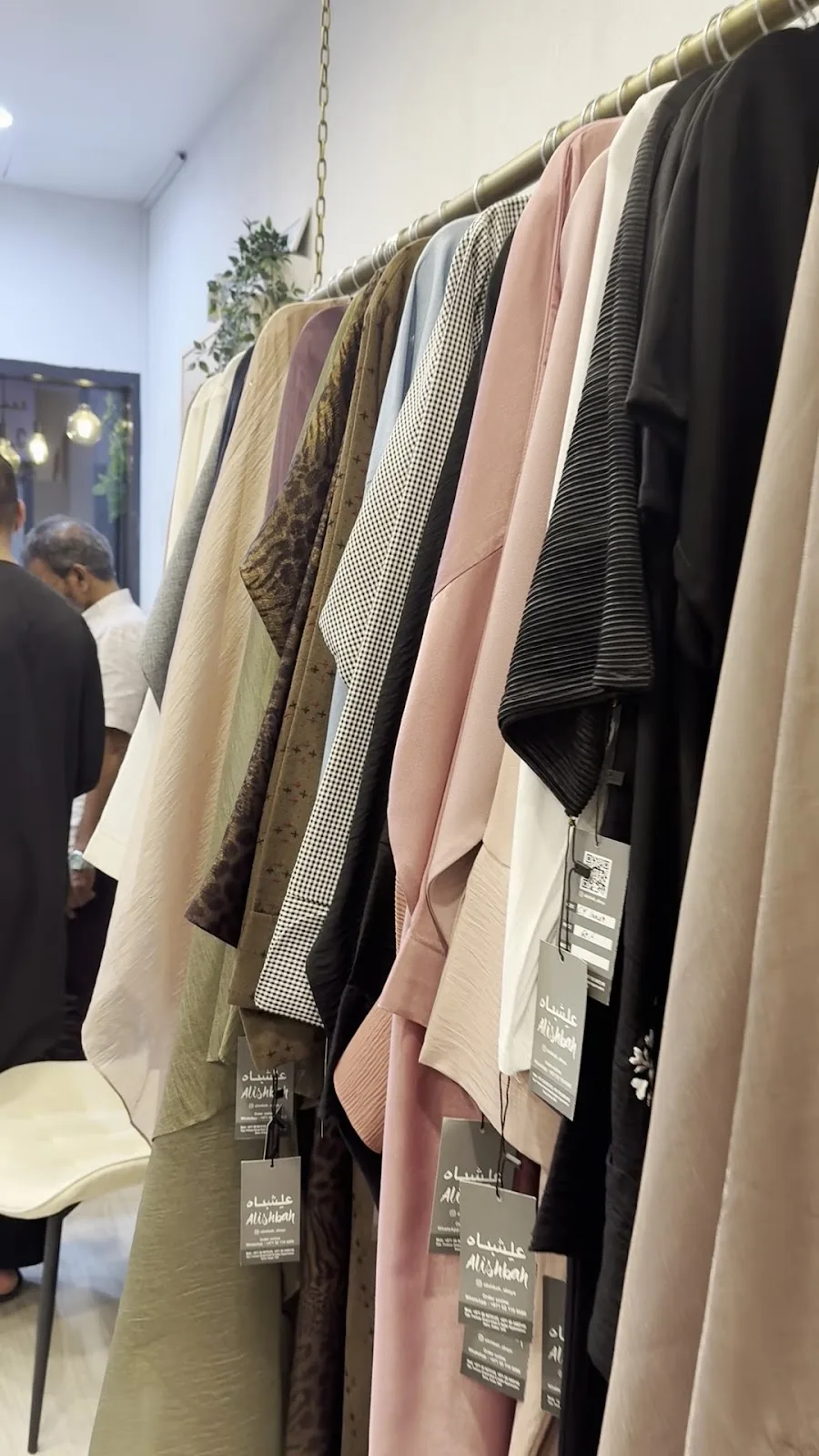 The Alishbah Abaya storefront in Deira with the illuminated shop sign reading Alishbah, Abaya Ladies Wears Tailoring