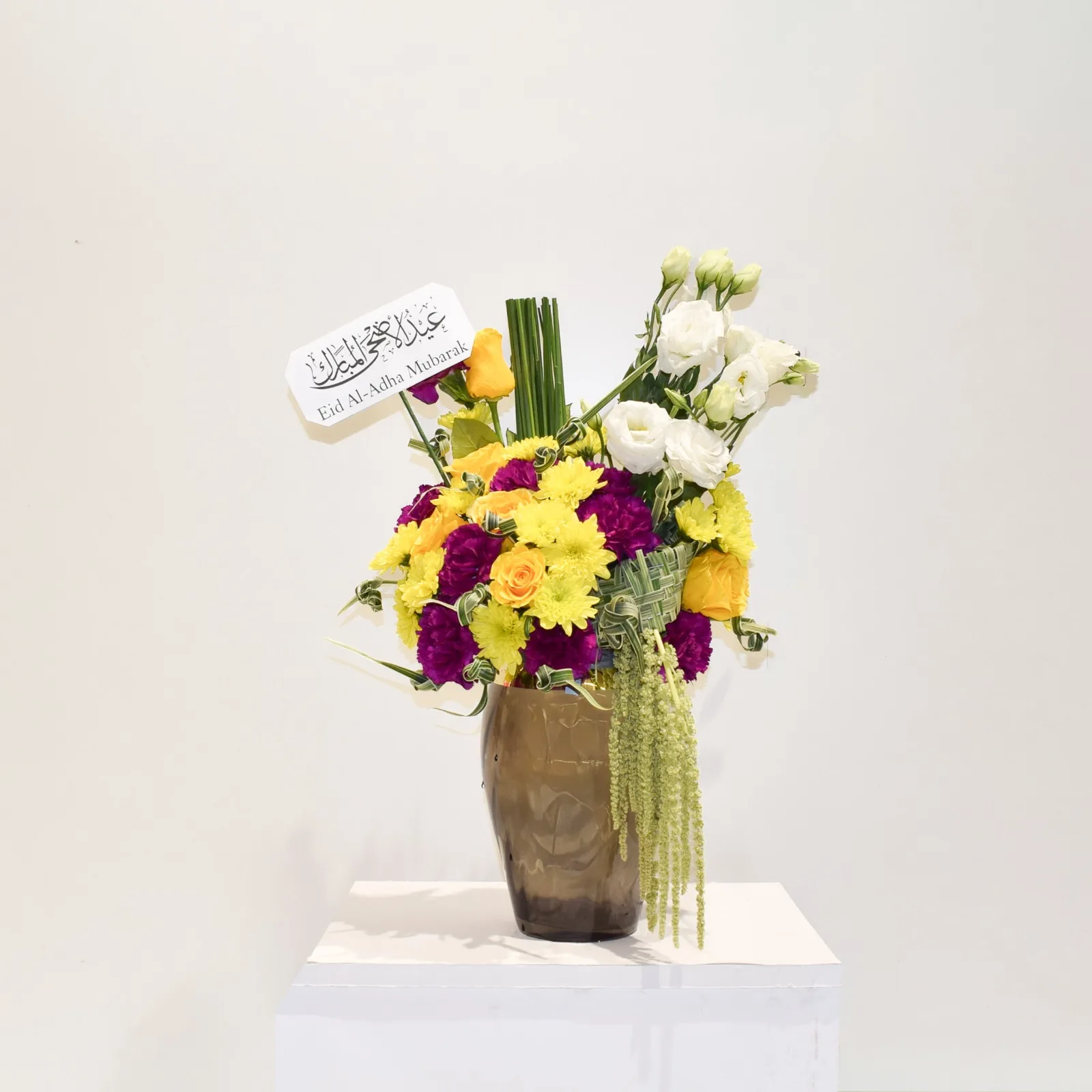 A festive arrangement of yellow and purple flowers in a vase