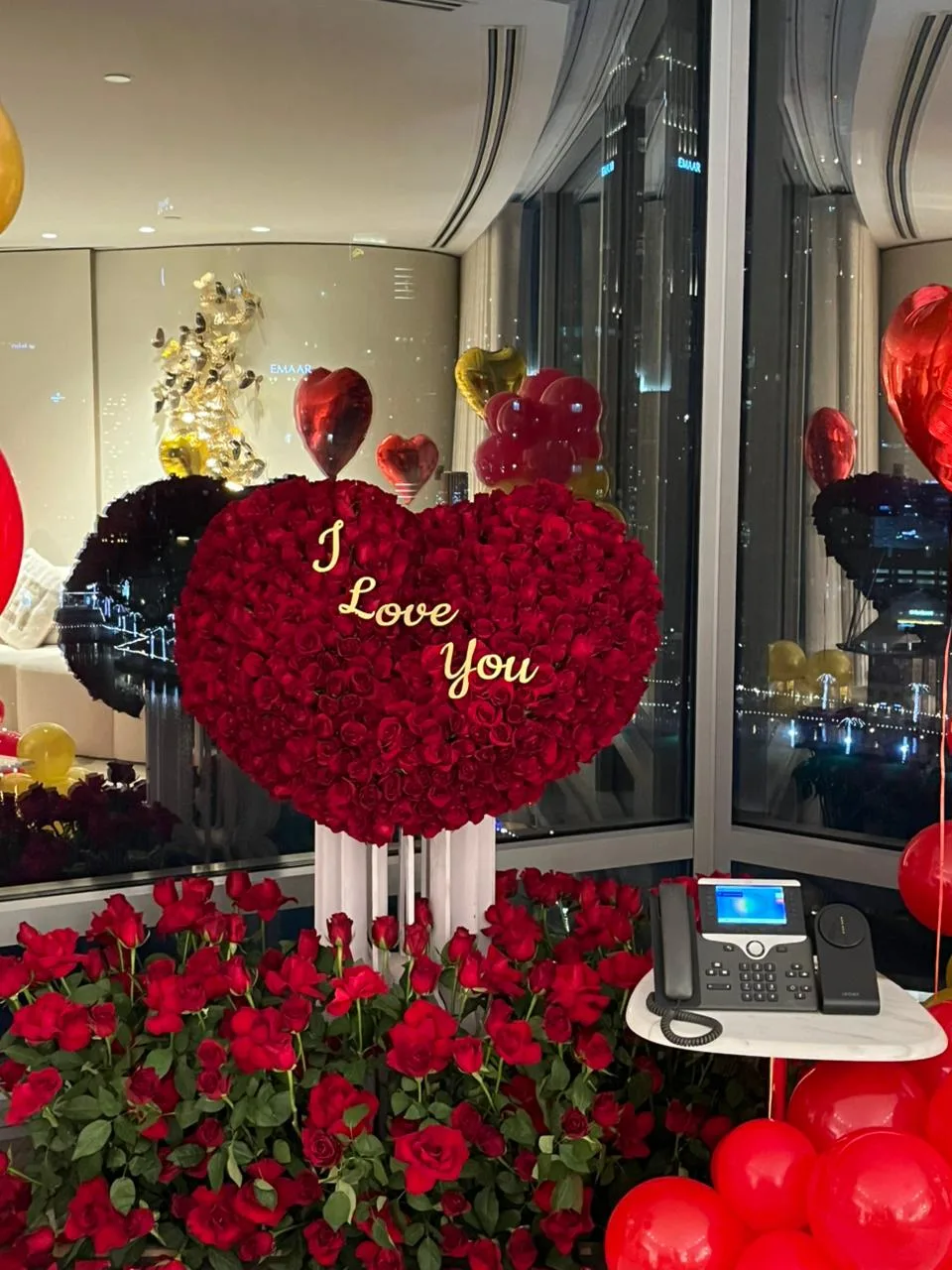 Large heart of red roses with 'I Love You' lettering, displayed by a window in Dubai