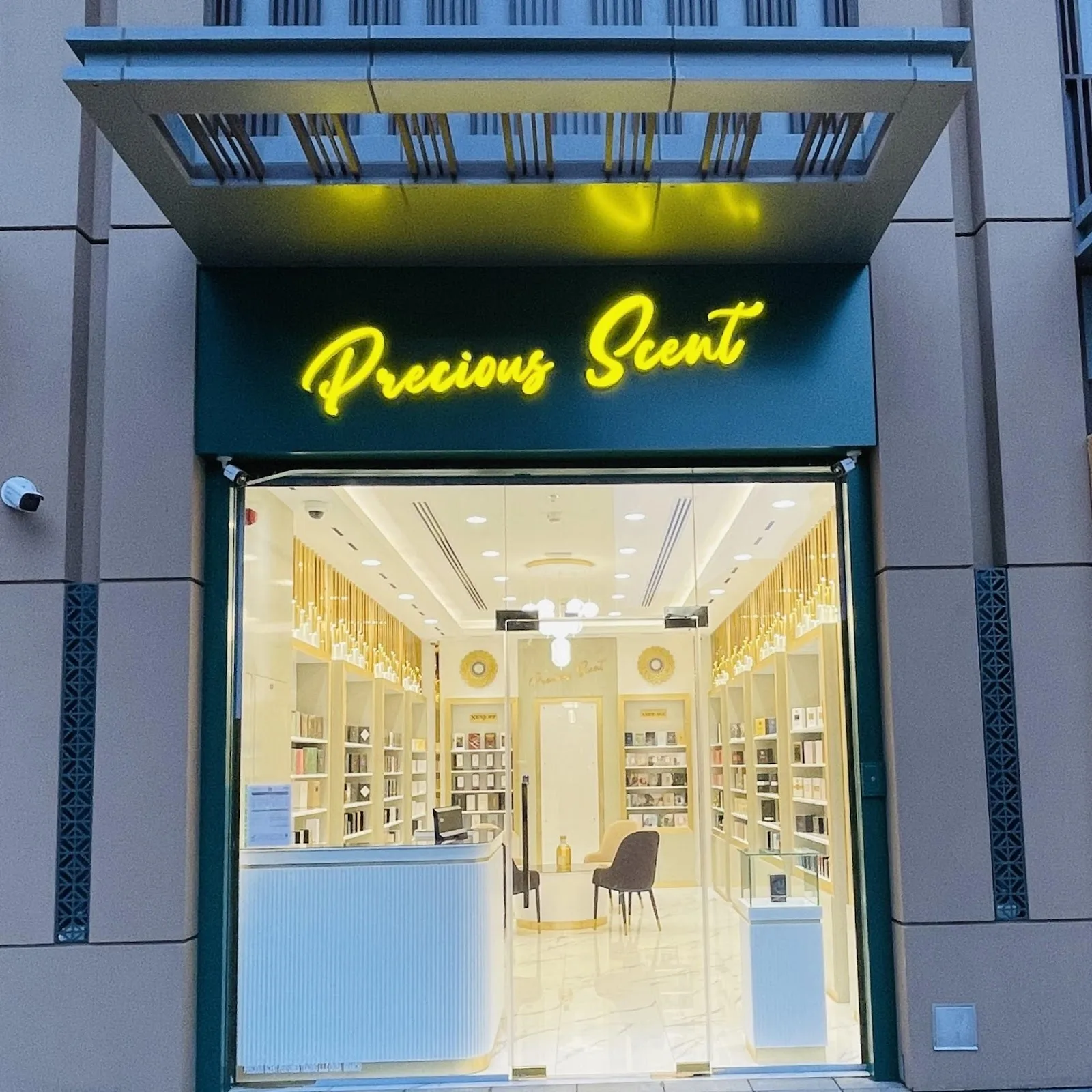 Precious Scent storefront with neon sign at dusk