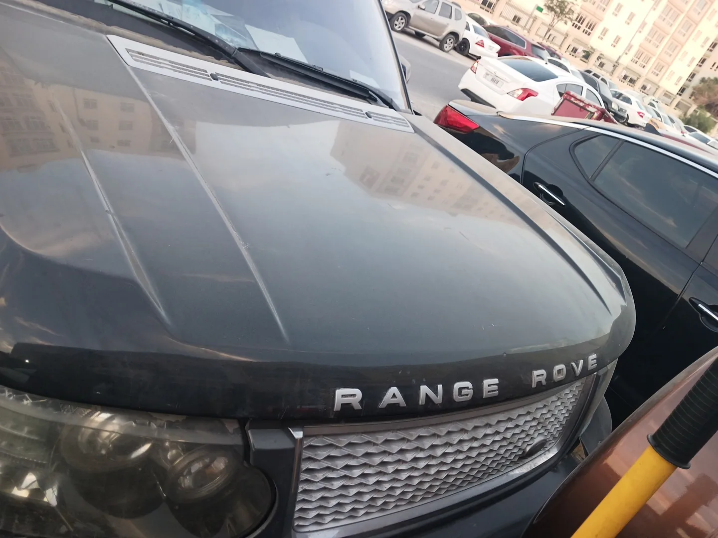 Close view of an SUV bonnet and grille parked outside the workshop