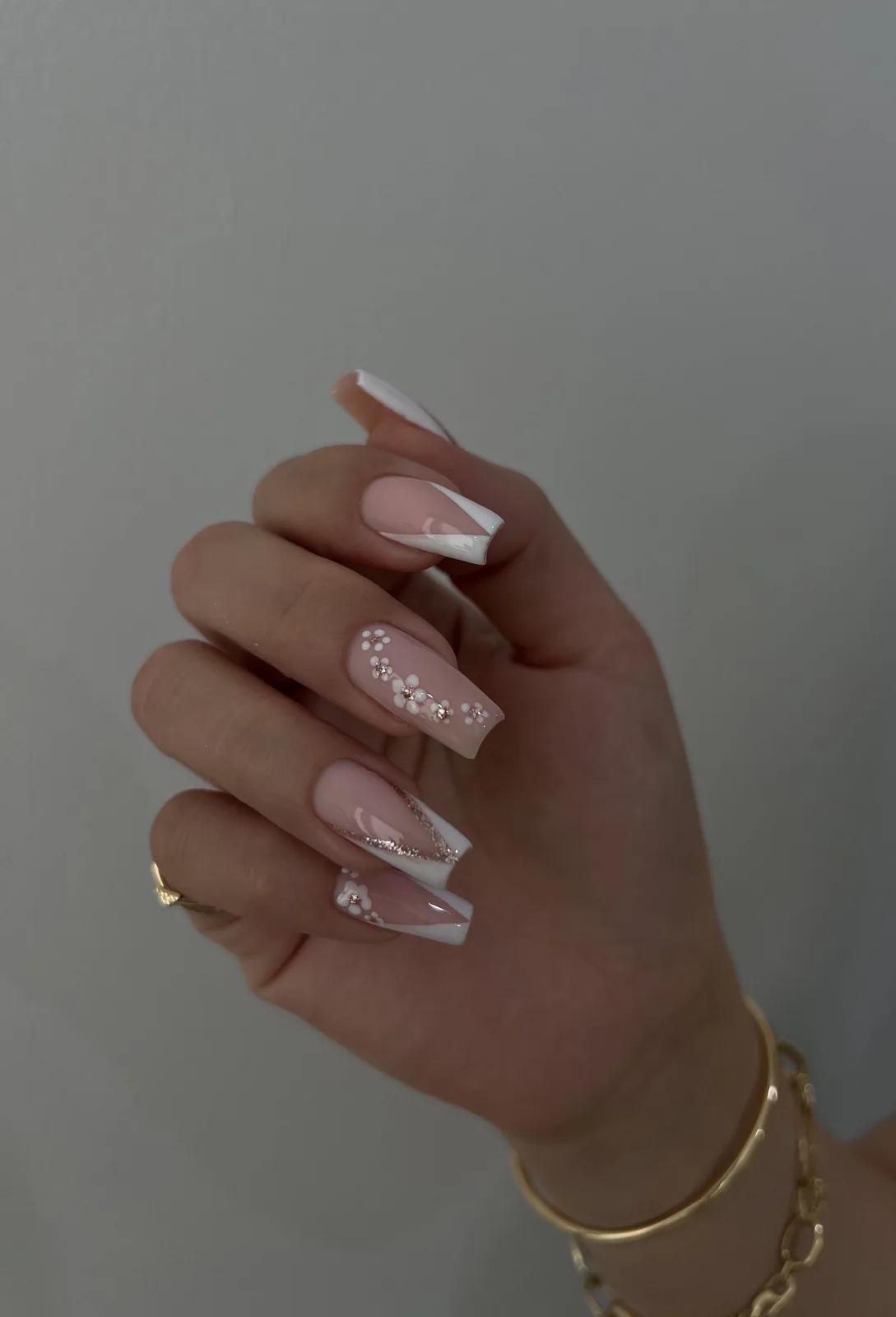 Long French coffin nail extensions with glitter