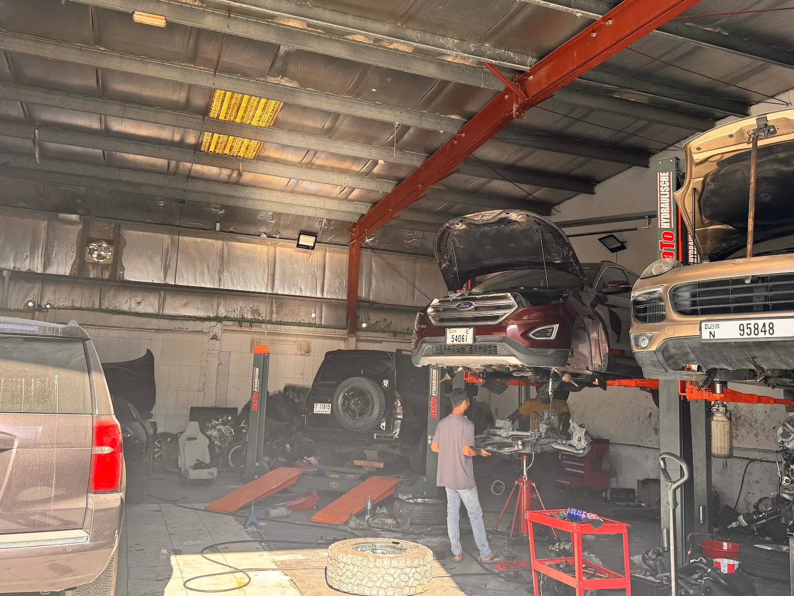Wide view of the AutoMedic workshop with cars on hydraulic lifts