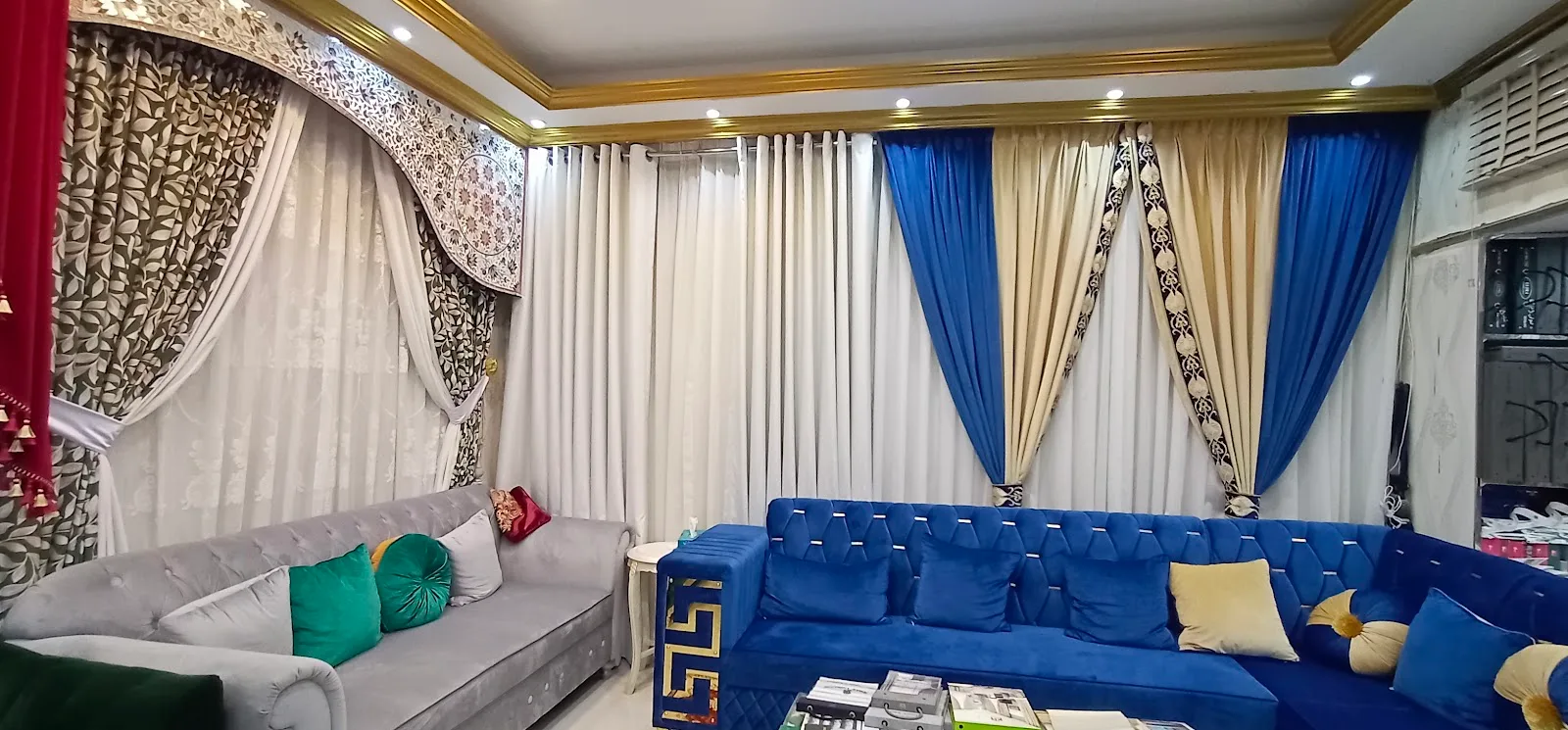 Showroom wall displaying a range of patterned, plain and coloured curtain styles