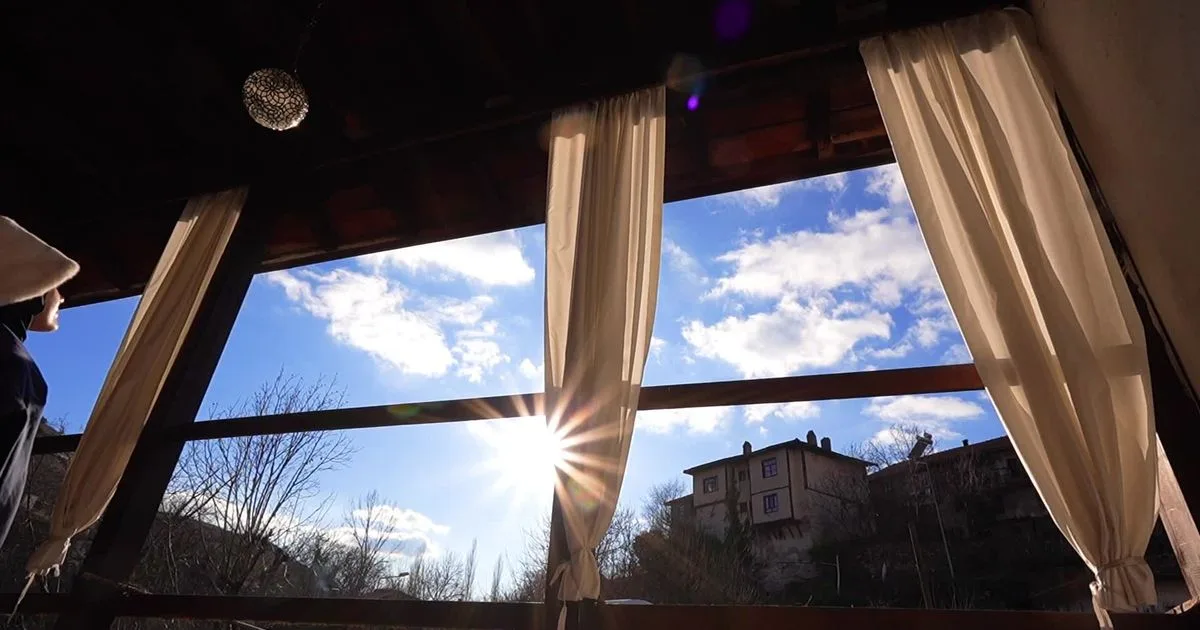 Light sheer curtains drawn beside large windows with daylight coming through