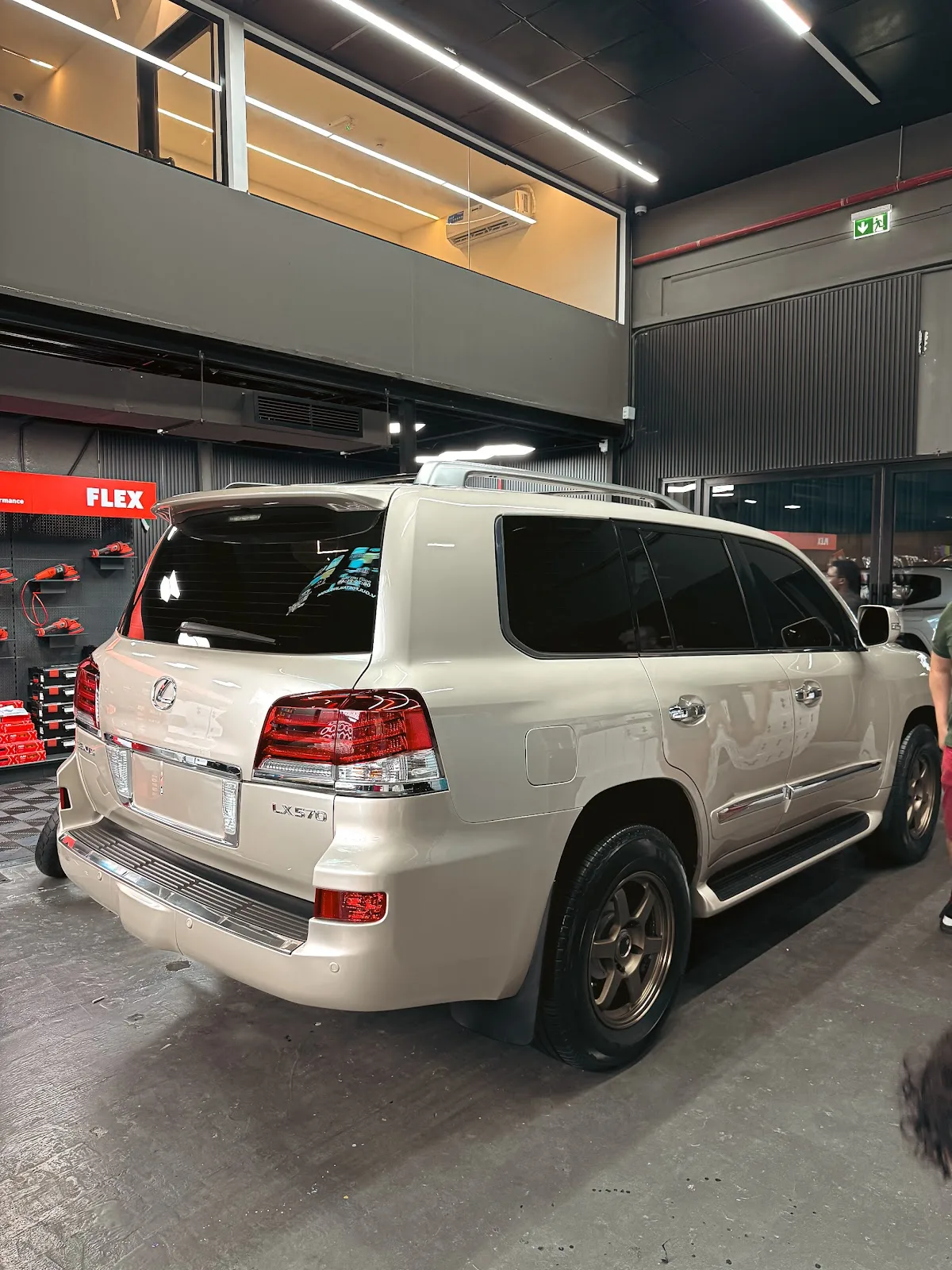 A pearl-white Lexus LX570 in the detailing bay