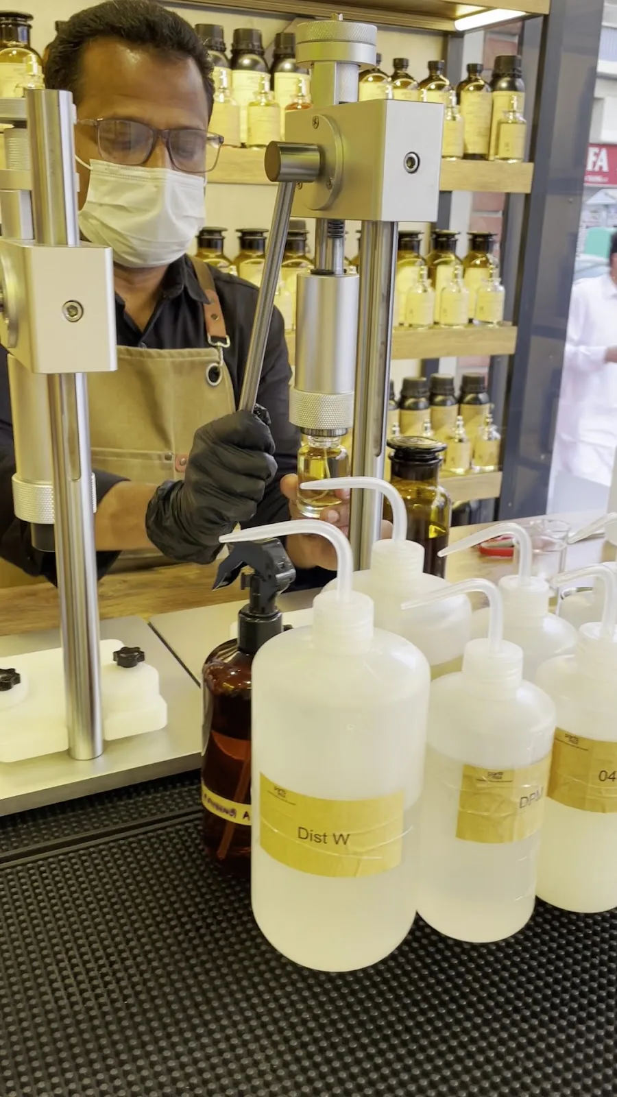 A bottle being capped at the Parfumix blending station