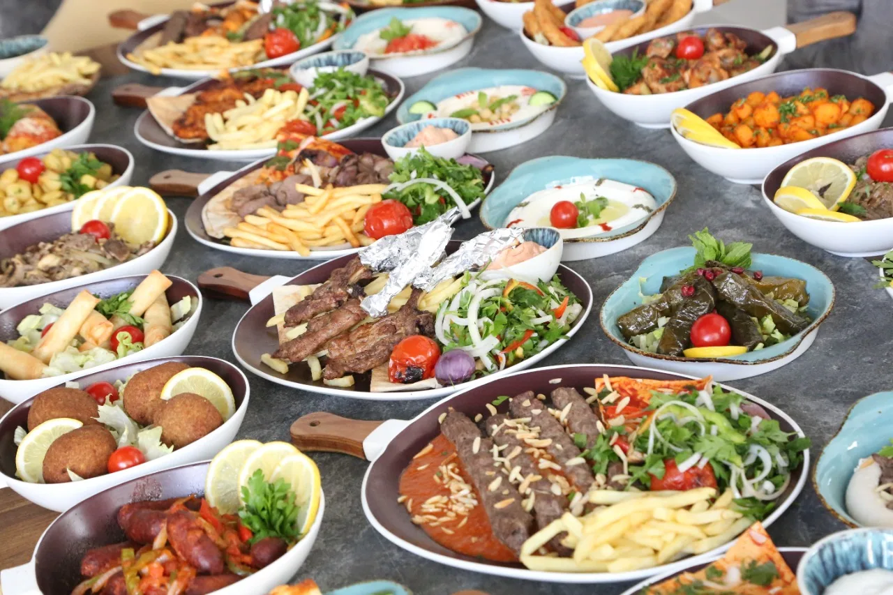 A large spread of many Lebanese dishes laid across a table