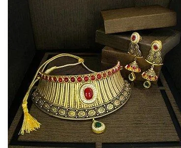 Gold bridal choker with a red centre stone and matching earrings in a display box