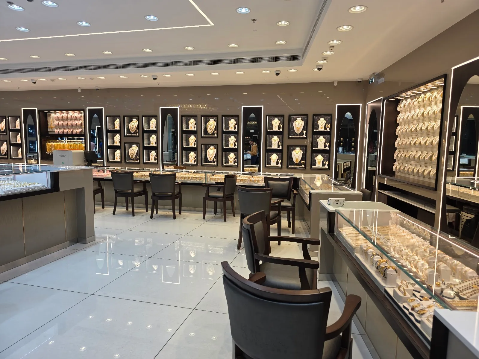Interior of the showroom with illuminated necklace displays and seating