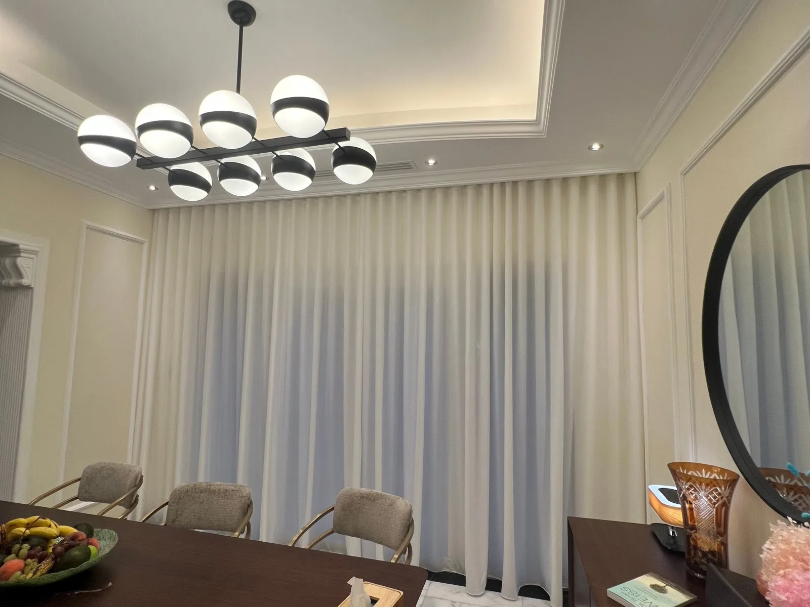 Elegant white S-fold sheer curtains in a Dubai dining room