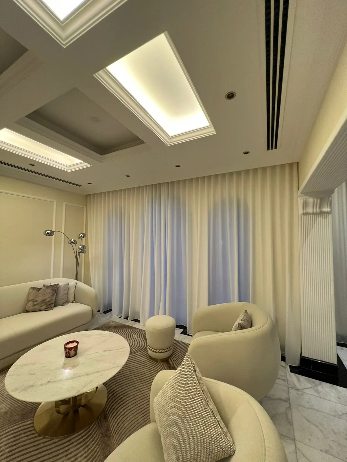 Floor-to-ceiling sheer curtains in a bright Dubai living room