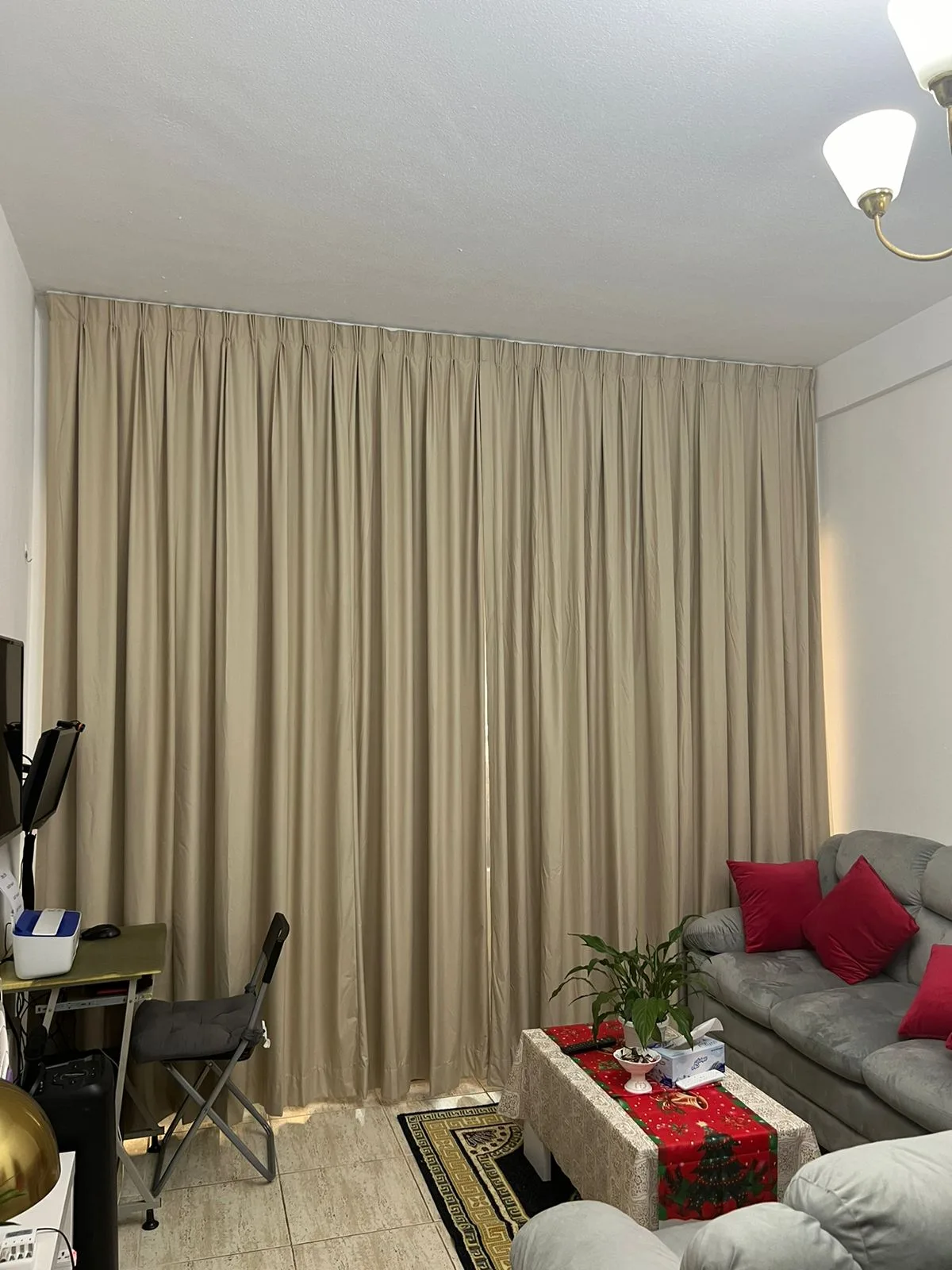 Beige blackout pinch-pleat curtains in a living room