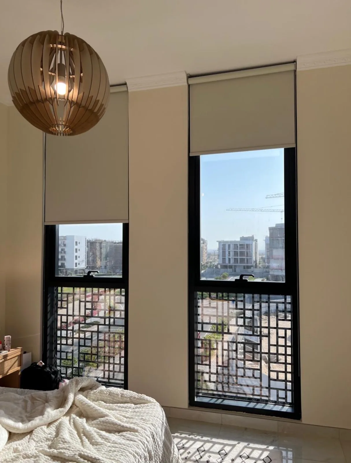 Layered taupe curtains and sheers in a bedroom