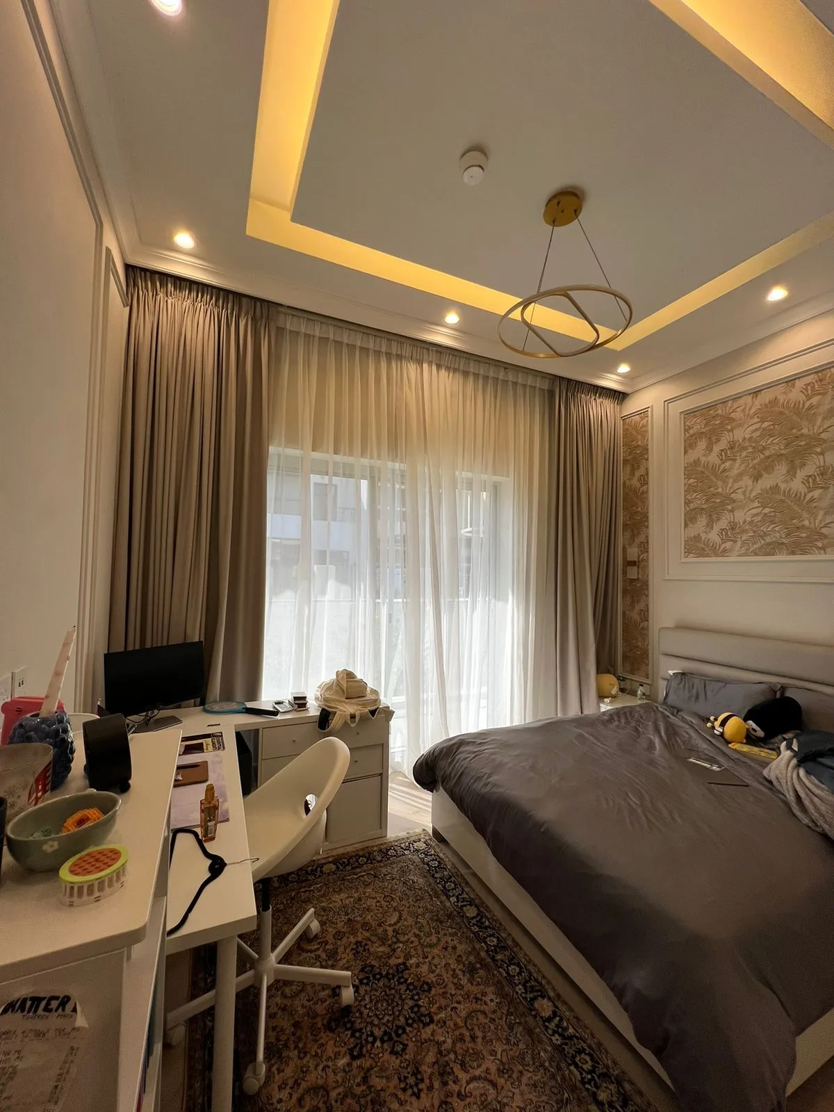 Roller blinds with a city view in a bedroom