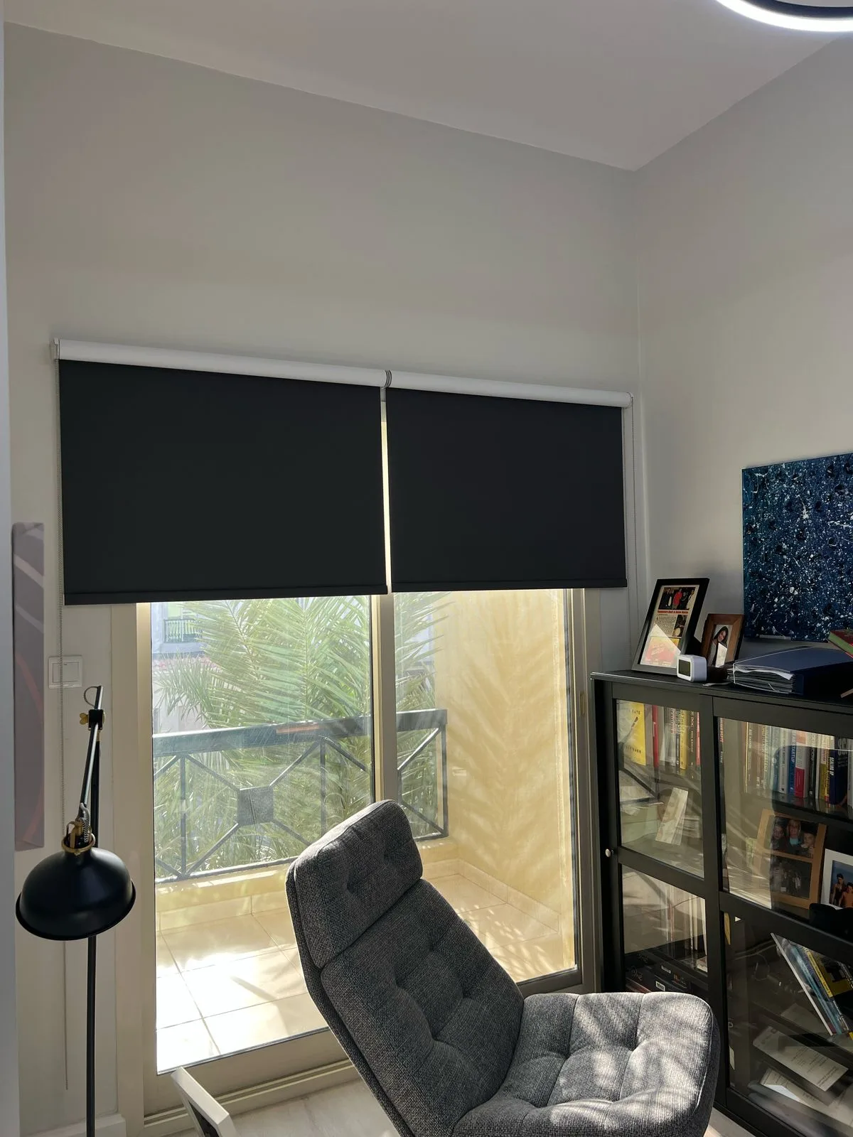 Wooden venetian blinds backlit beside soft sheers