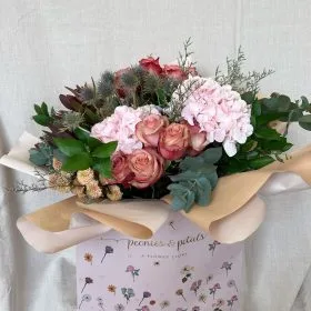 Pink hydrangea and rose arrangement with a branded gift card