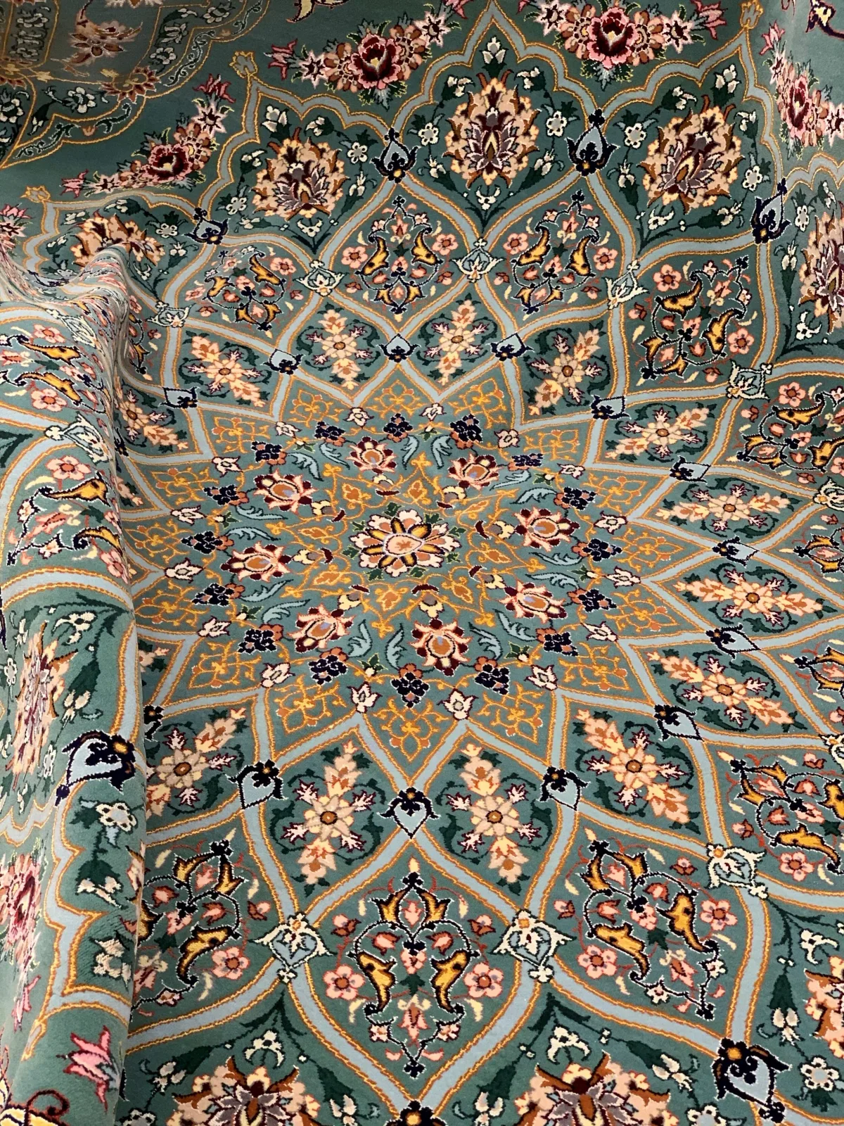 Sage-green silk carpet with a symmetrical floral medallion
