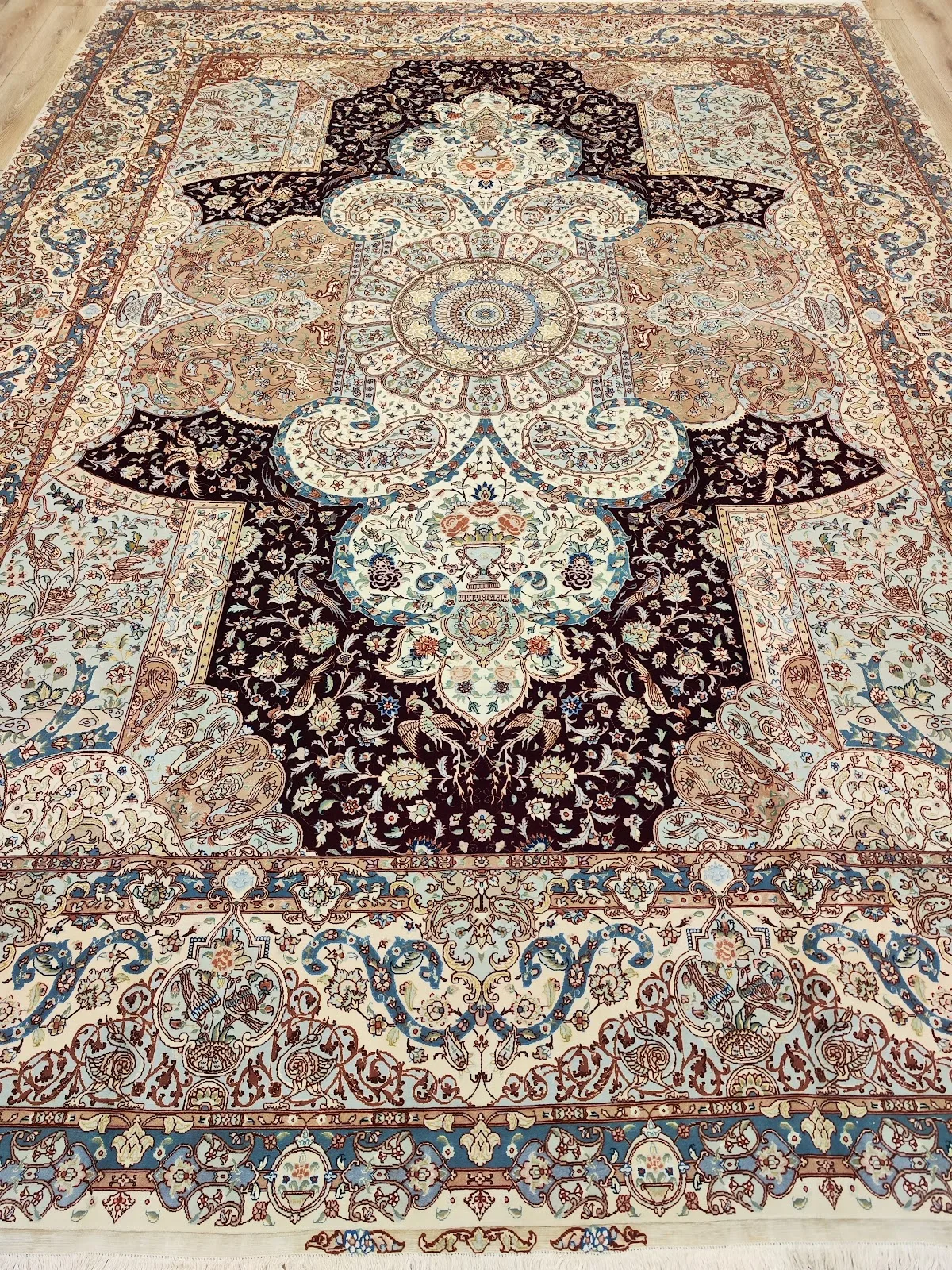 Ivory and blue wool Persian carpet with an ornate paisley field
