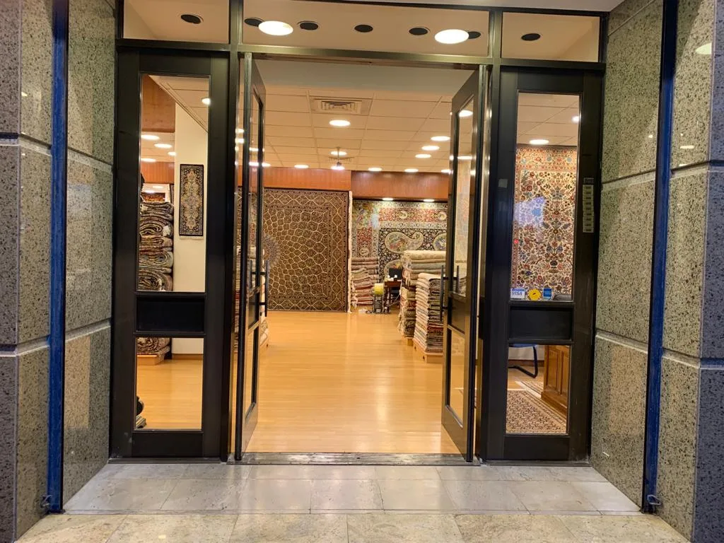 Glass entrance of the Farco showroom with carpets displayed inside