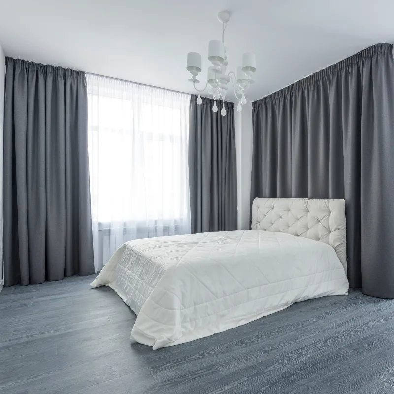 Grey curtains and sheers in a bedroom