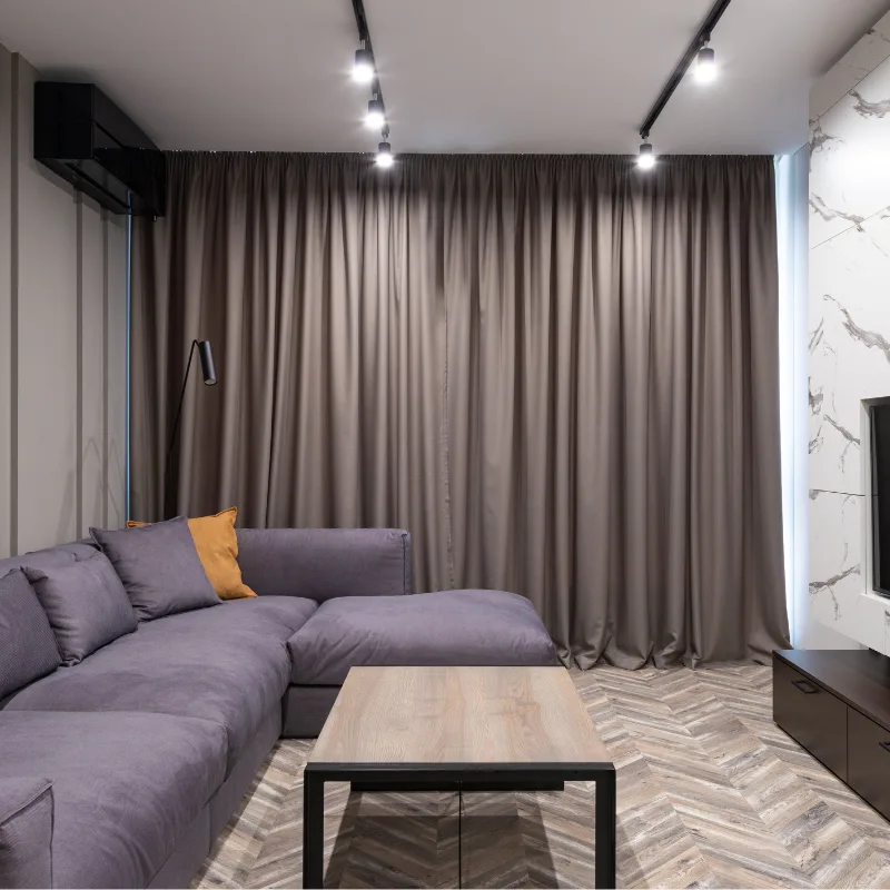Floor-length pleated curtains in a living room