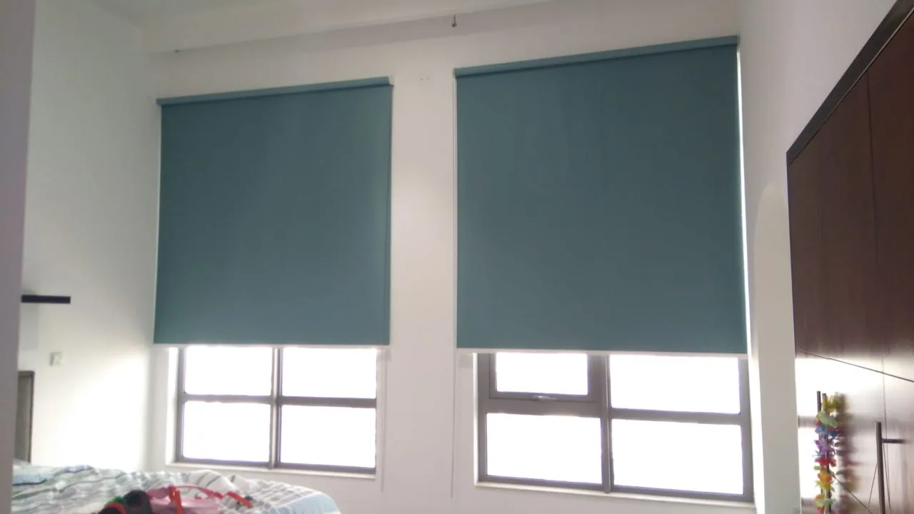 Teal roller blinds fitted to bedroom windows